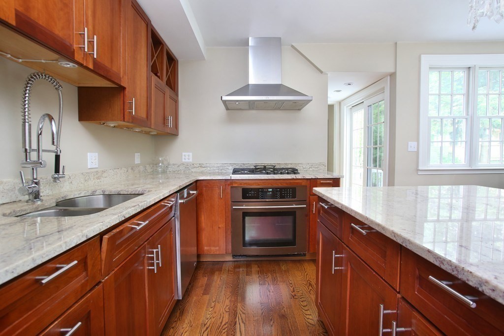204 Pleasant Street Newton, MA 02459 - Photo 3 of 27 a kitchen with stainless steel appliances granite countertop a sink a stove and a wooden floors