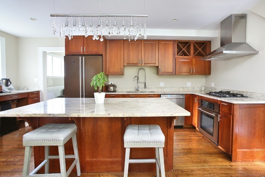 204 Pleasant Street Newton, MA 02459 - Photo 5 of 27 a kitchen with stainless steel appliances granite countertop a sink a stove and a wooden floors