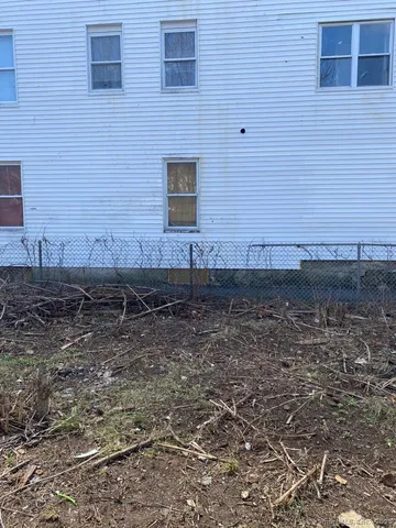 a view of a brick house with yard
