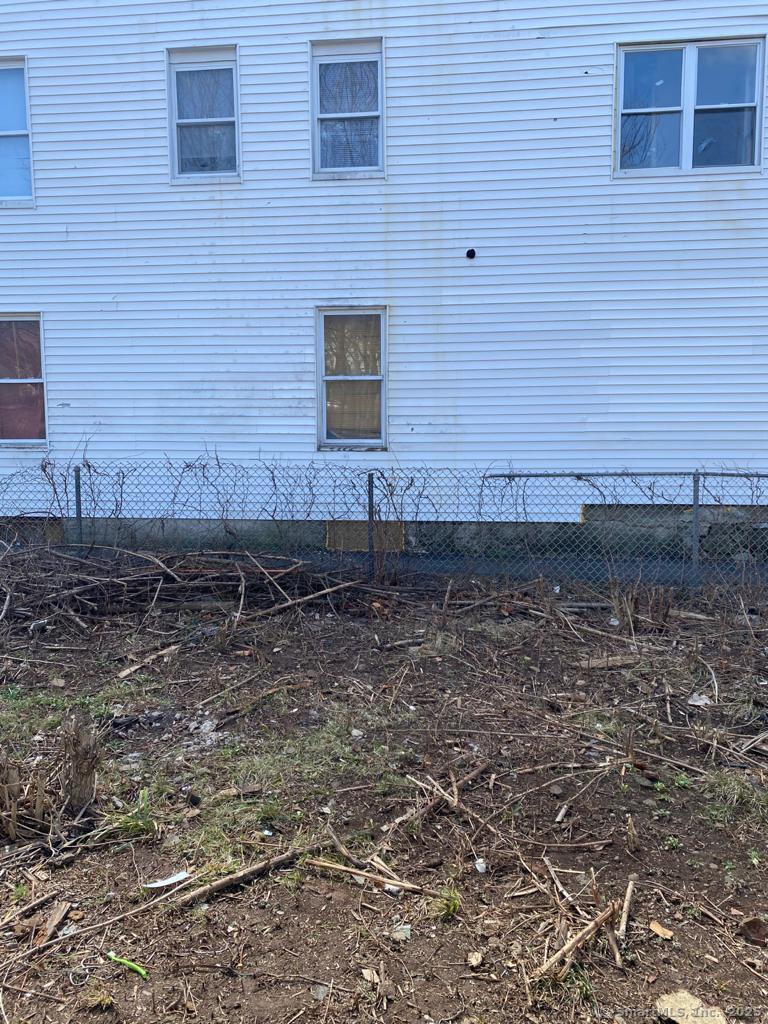 25 Violet Street Waterbury, CT 06704 - Photo 3 of 4 a view of a brick house with yard