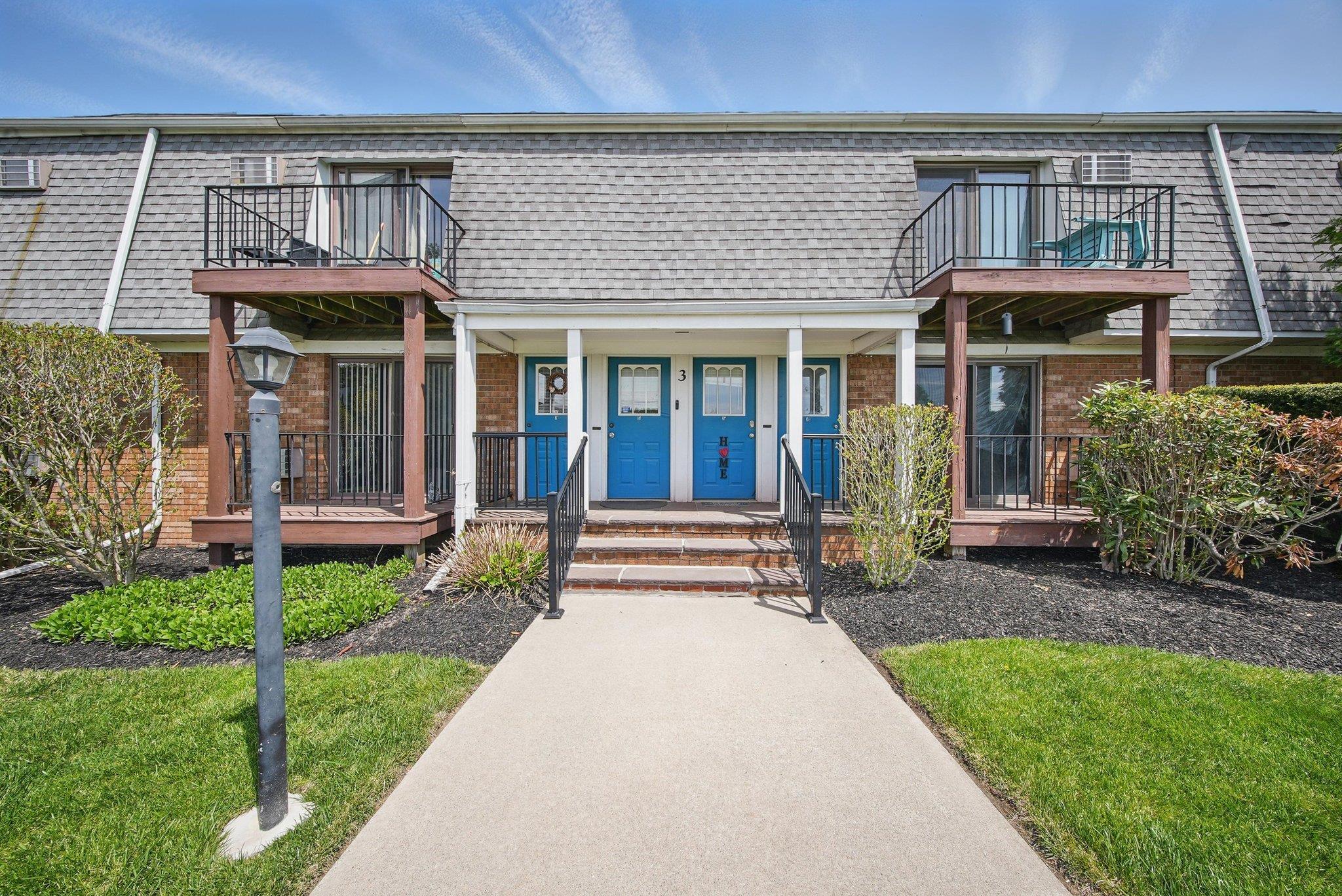 3 Fortune Road West, Unit 3E Middletown, NY 10941 - Photo 1 of 1 View of front of home with a balcony, mansard roof, brick siding, and covered porch