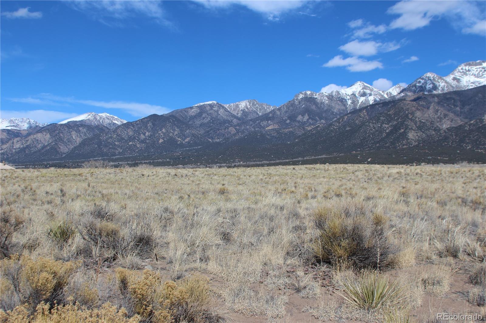 306 Cottonwood Creek Road Crestone, CO 81131 - Photo 7 of 15 a view of a dry yard with mountains in the background