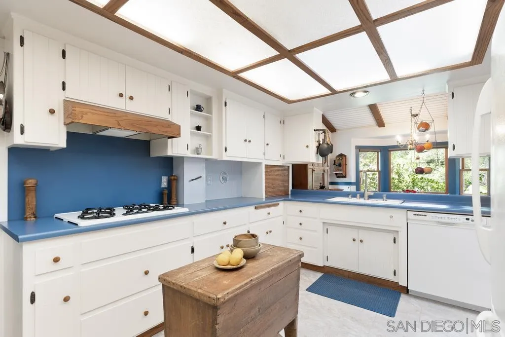 13636 Jack Rabbit Road Poway, CA 92064 - Photo 13 of 29 a kitchen with white cabinets and window