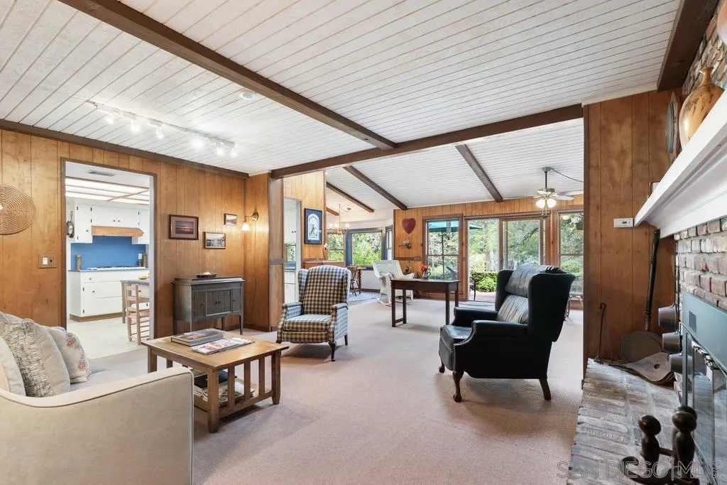13636 Jack Rabbit Road Poway, CA 92064 - Photo 17 of 29 a living room with furniture a fireplace and large windows