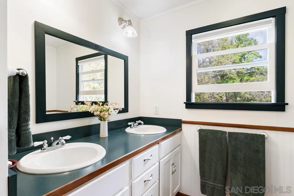 13636 Jack Rabbit Road Poway, CA 92064 - Photo 20 of 29 a bathroom with a granite countertop sink and a large mirror