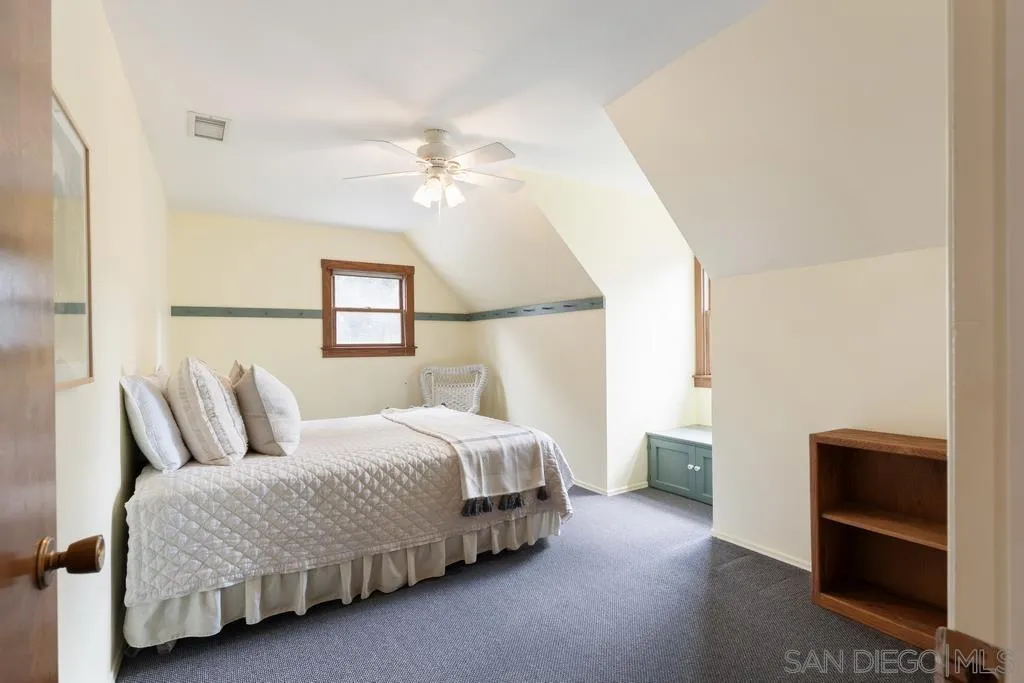 13636 Jack Rabbit Road Poway, CA 92064 - Photo 23 of 29 a bedroom with a bed and a chandelier