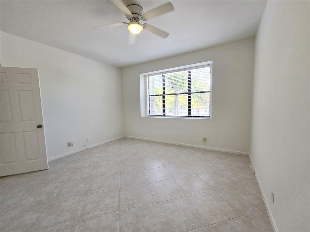 5800 Coach House Circle, Unit D Boca Raton, FL 33486 - Photo 17 of 23 an empty room with a window and a fan