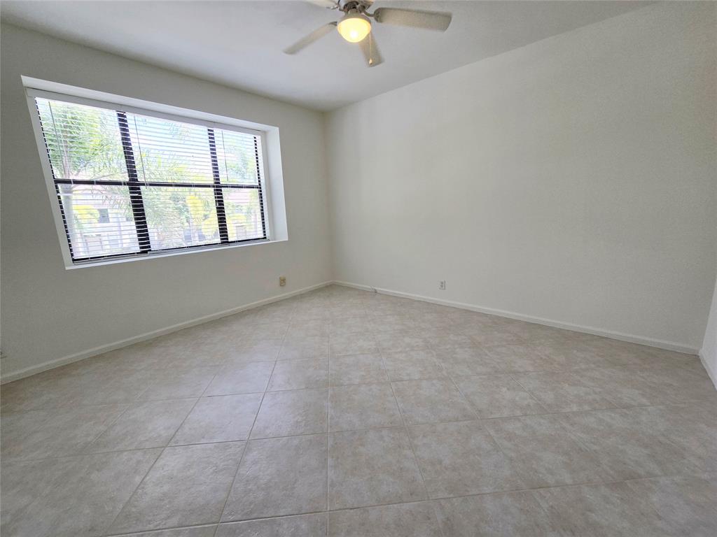 5800 Coach House Circle, Unit D Boca Raton, FL 33486 - Photo 18 of 23 an empty room with window and carpet