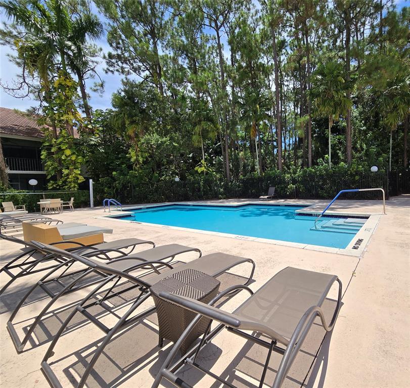 5800 Coach House Circle, Unit D Boca Raton, FL 33486 - Photo 21 of 23 a view of a outdoor space with swimming pool