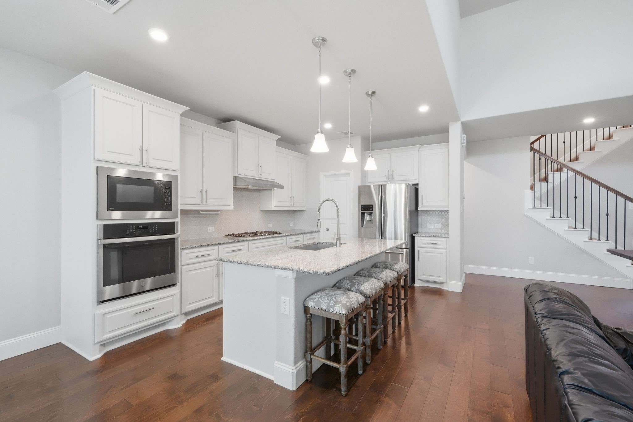 2809 Andante Green Drive Spring, TX 77386 - Photo 10 of 50 a kitchen with stainless steel appliances kitchen island granite countertop a table chairs refrigerator and microwave