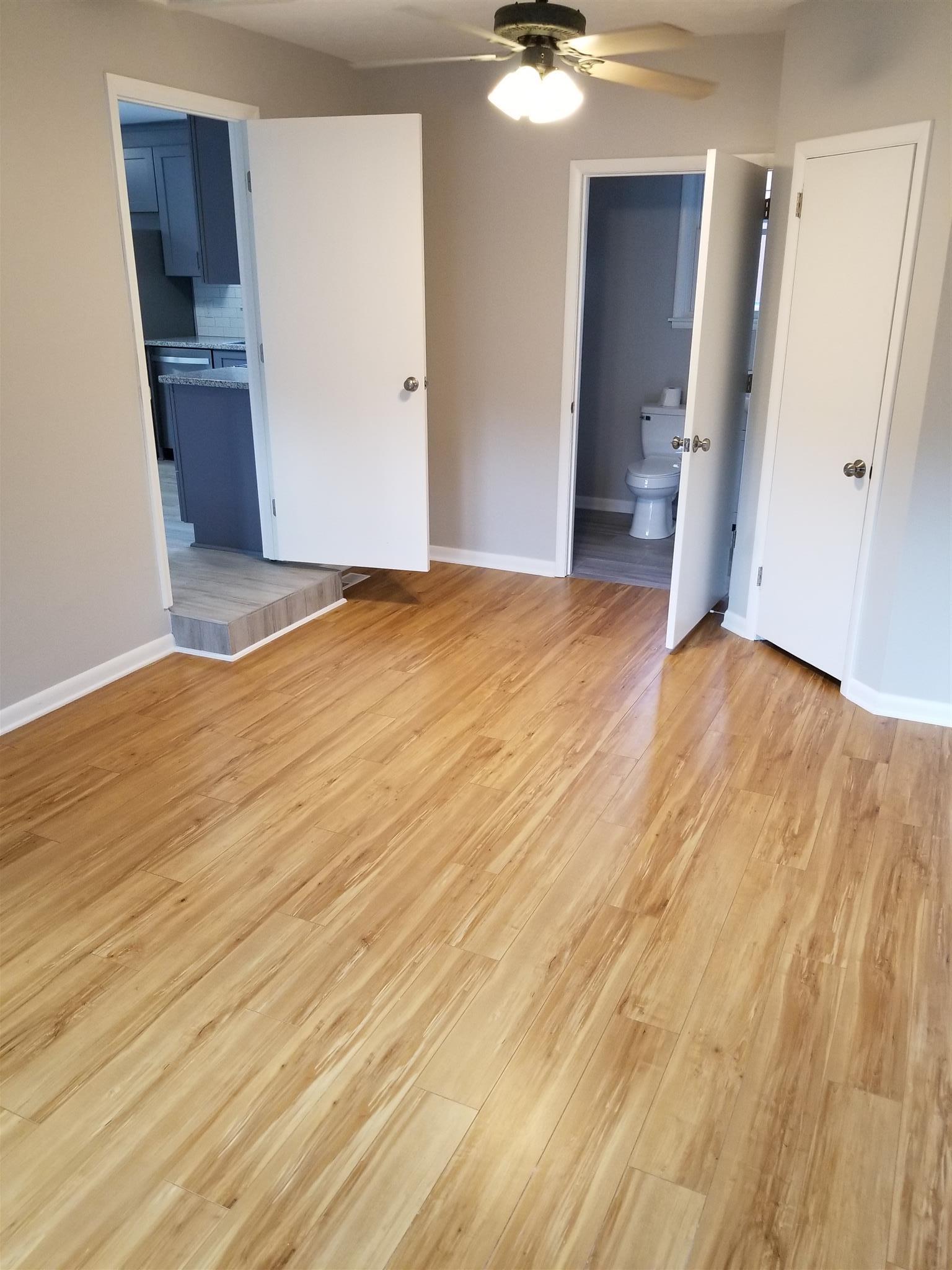 207 South Valley Road Hendersonville, TN 37075 - Photo 17 of 21 an empty room with wooden floor and entrance door