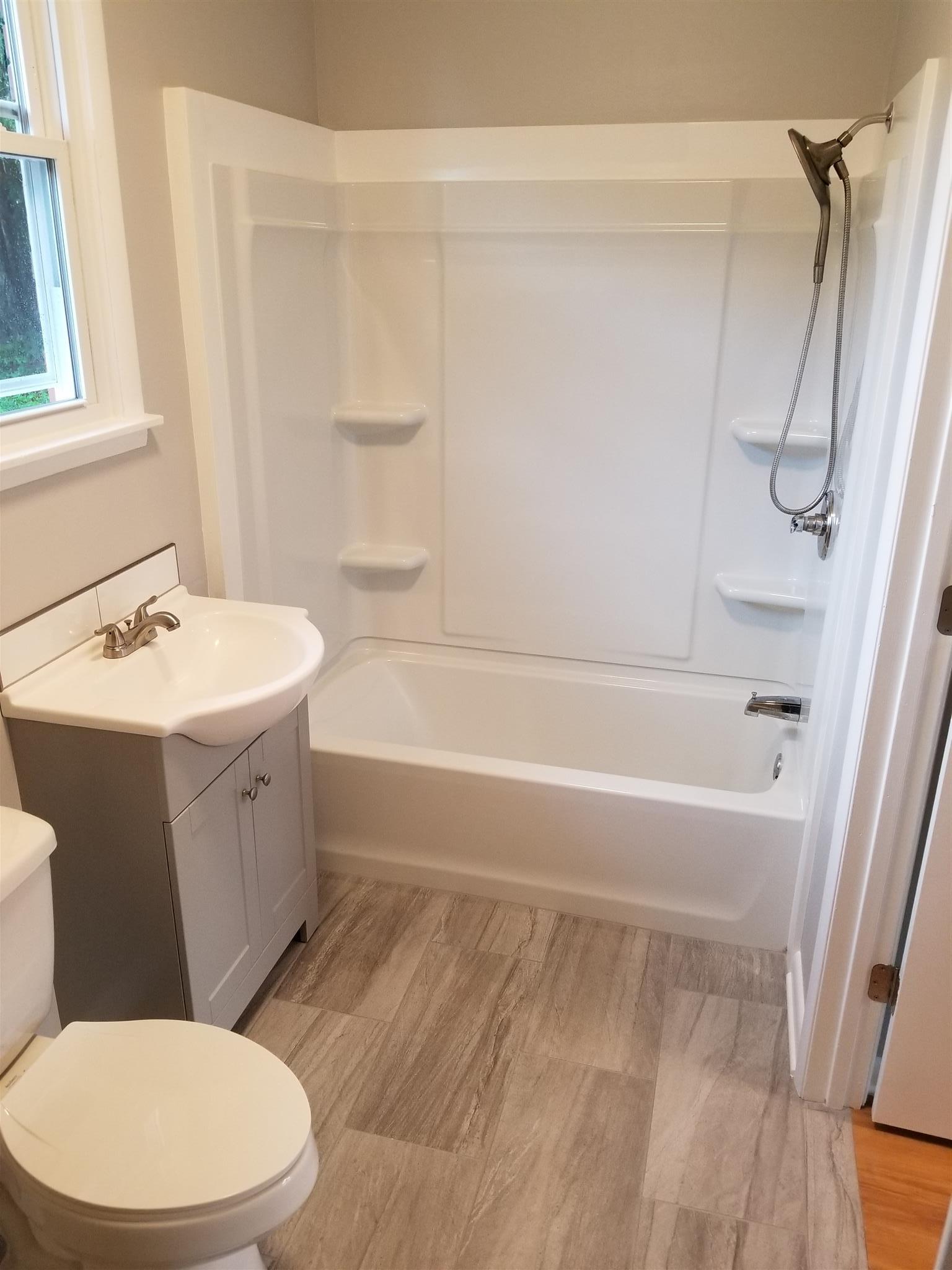 207 South Valley Road Hendersonville, TN 37075 - Photo 18 of 21 a bathroom with a sink a toilet and shower