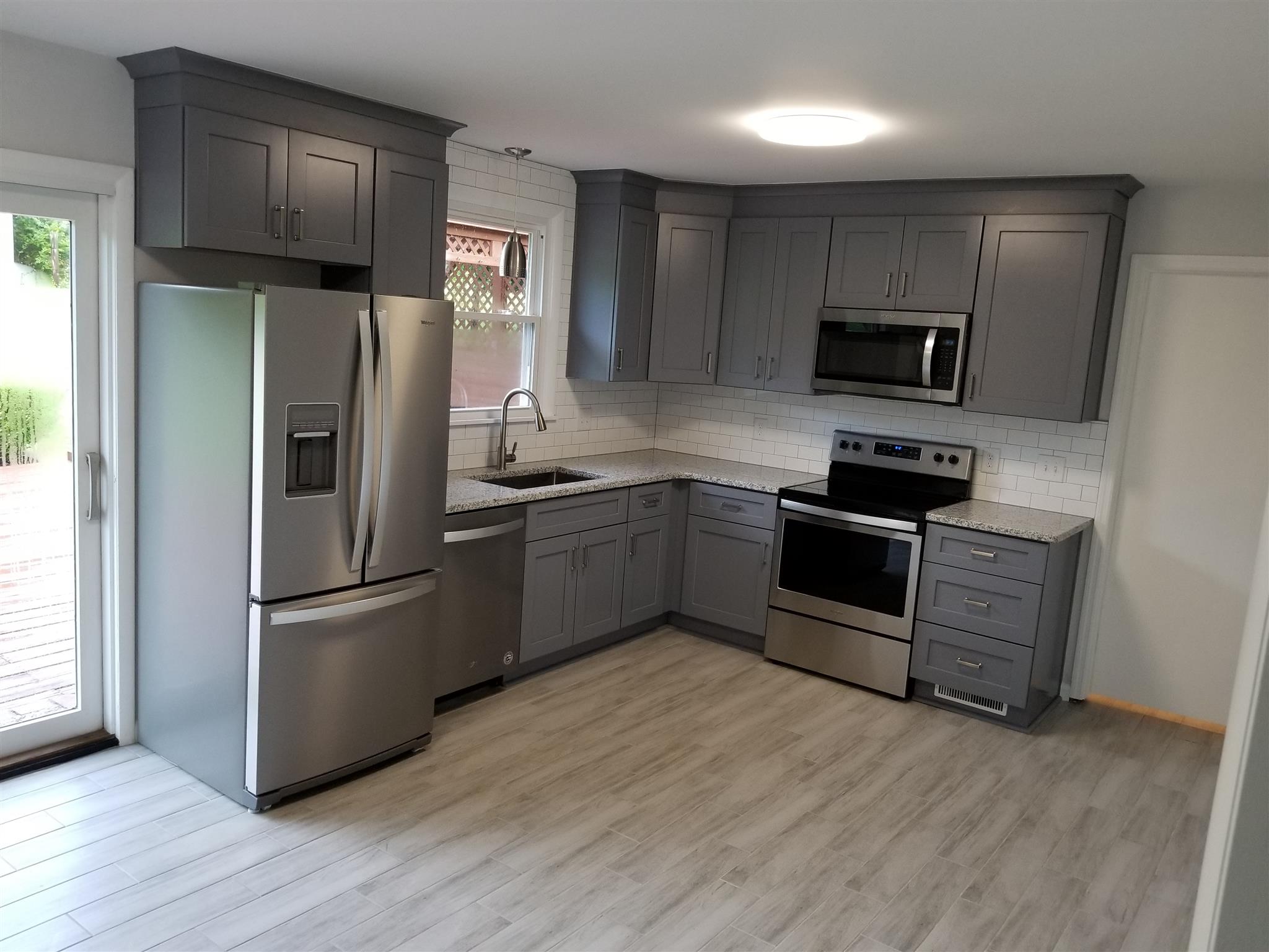 207 South Valley Road Hendersonville, TN 37075 - Photo 6 of 21 a kitchen with wooden cabinets and stainless steel appliances