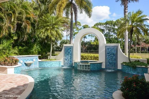 a view of a house with pool and sitting area