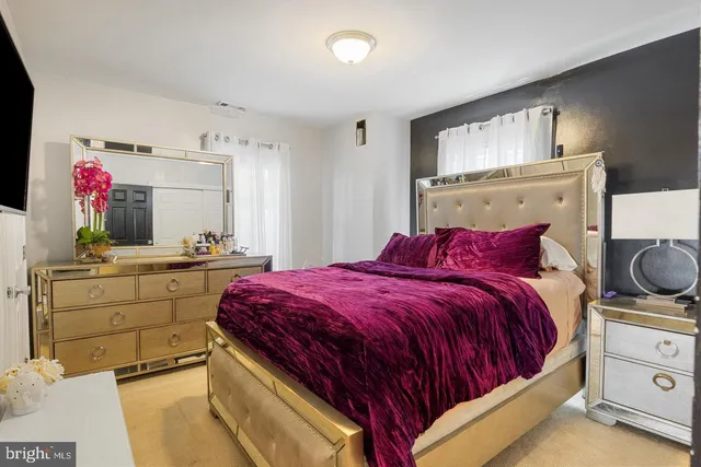 a bed room with a bed and a dresser