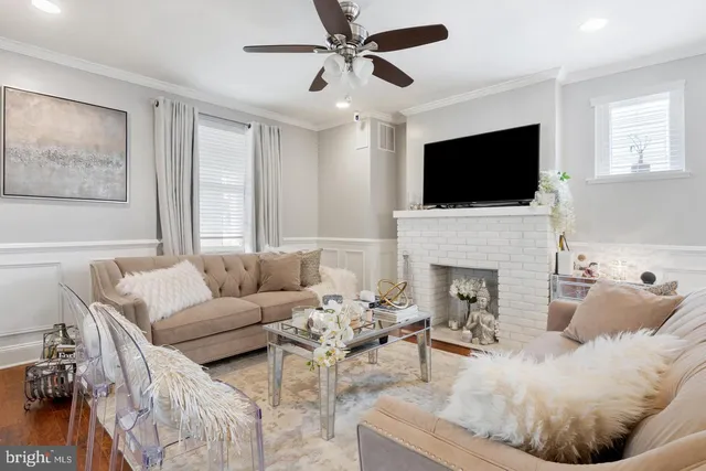a living room with furniture a fireplace and a flat screen tv