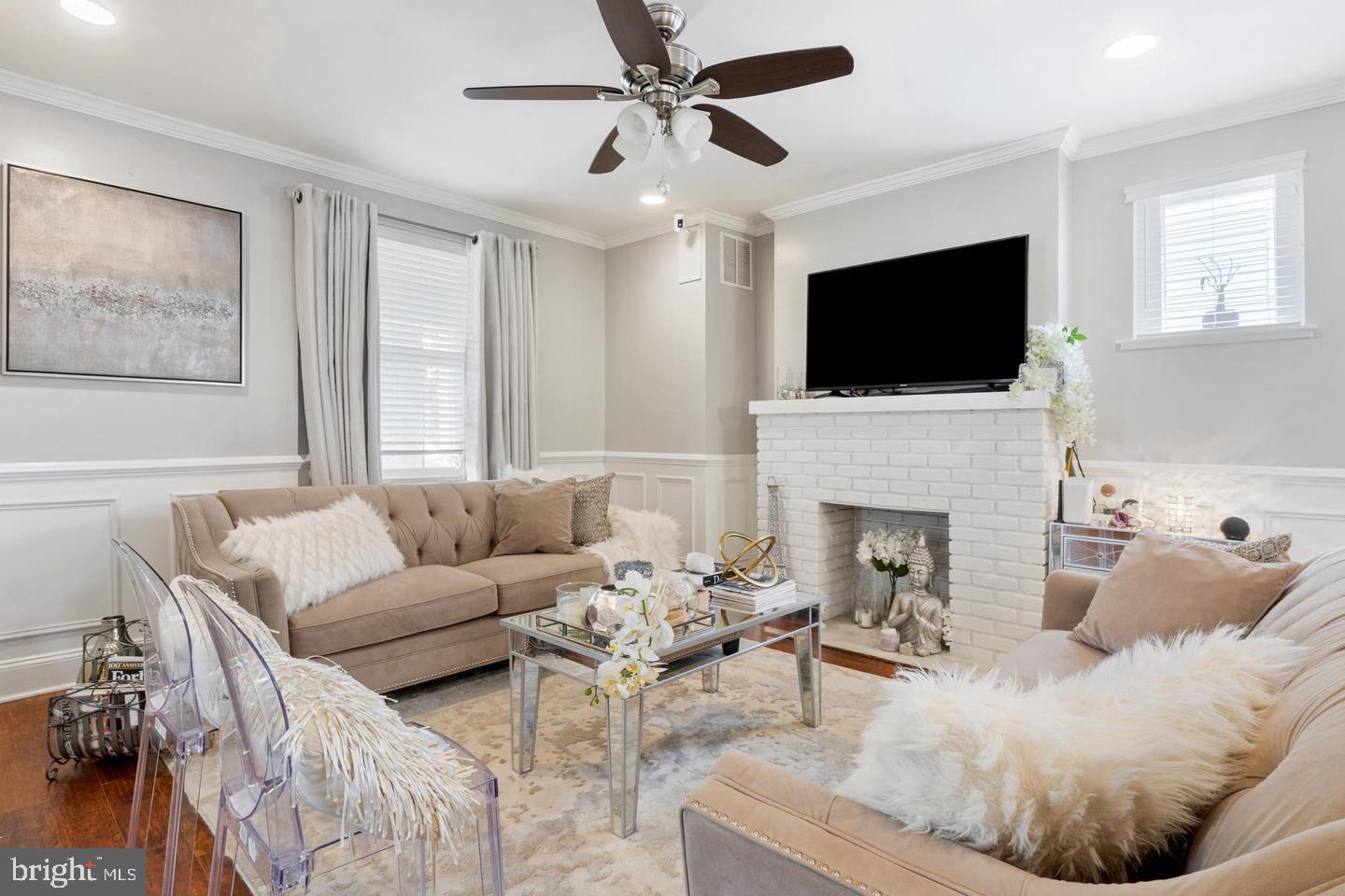 2808 East Northern Parkway Baltimore, MD 21214 - Photo 3 of 17 a living room with furniture a fireplace and a flat screen tv
