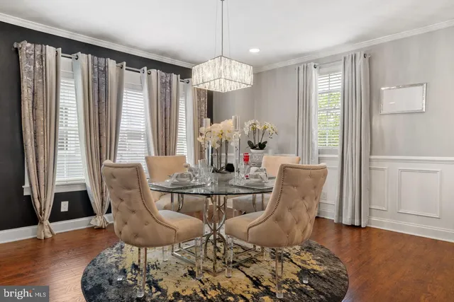 a dining room with furniture window and wooden floor