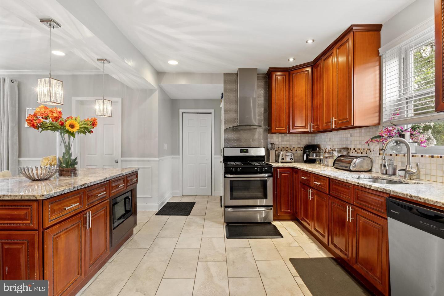 2808 East Northern Parkway Baltimore, MD 21214 - Photo 5 of 17 a kitchen with stainless steel appliances granite countertop a stove sink and cabinets