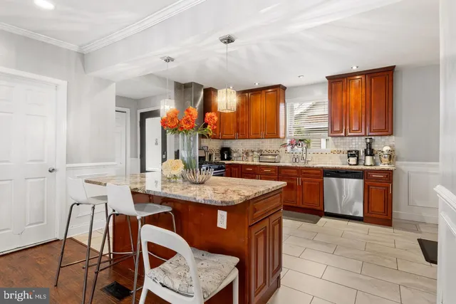 a kitchen with a granite countertop sink stove and cabinets