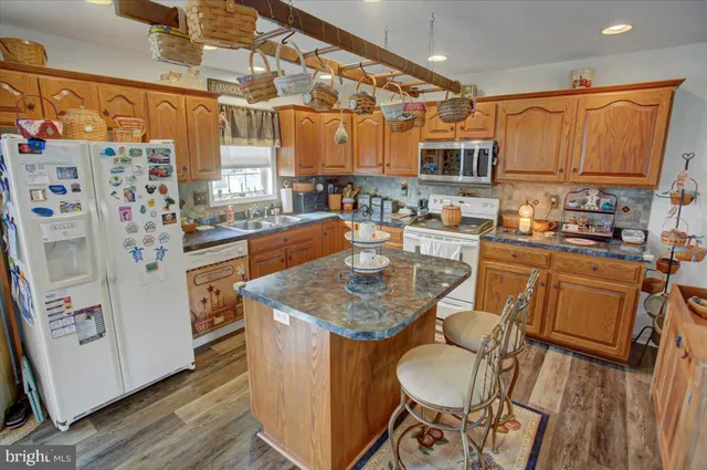 a dining room with furniture a rug and wooden floor