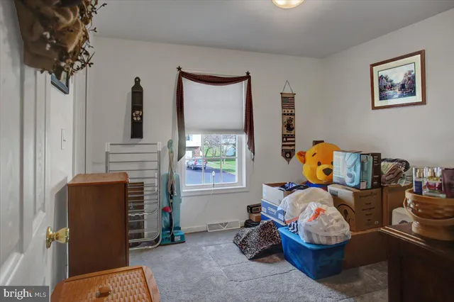 a bed room with furniture and a mirror