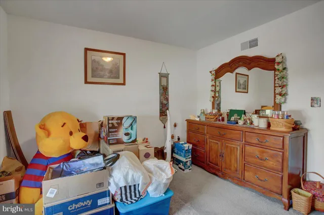 a bedroom with a bed and a mirror