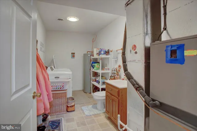 a utility room with sink dryer and washer