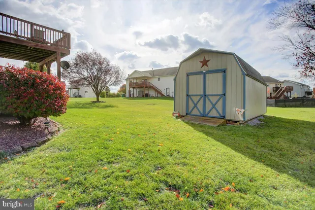 a view of a big house with a big yard and large trees
