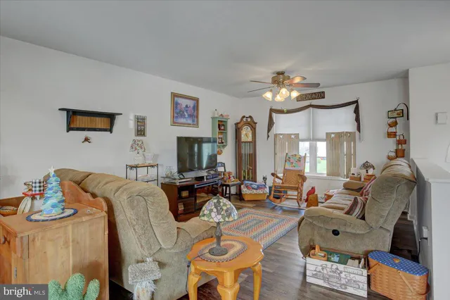 a kitchen with stainless steel appliances granite countertop a refrigerator a sink dishwasher a stove and a dining table with wooden floor