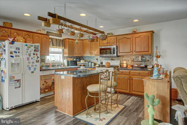 a kitchen with stainless steel appliances granite countertop a refrigerator and microwave