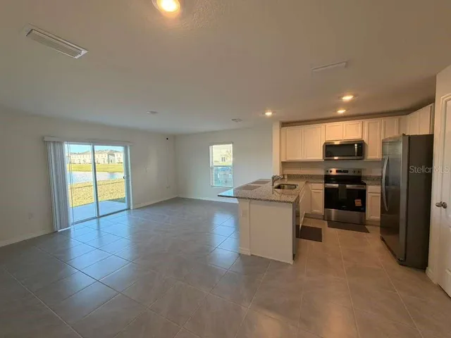 a kitchen with a sink stainless steel appliances and cabinets