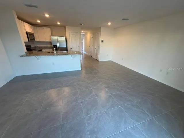 a view of a kitchen with a sink and cabinets