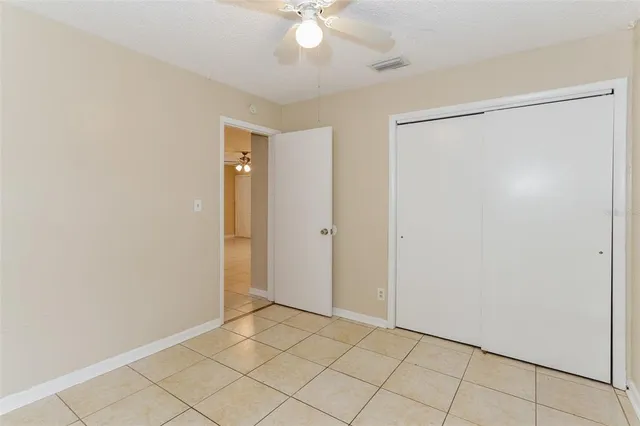a view of an empty room with a fan