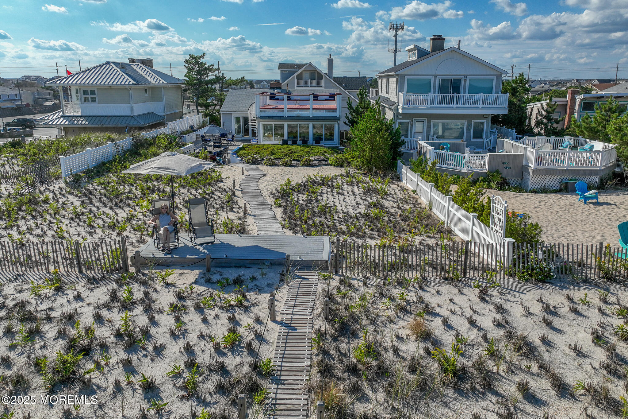 a view of a house with a yard and sitting area
