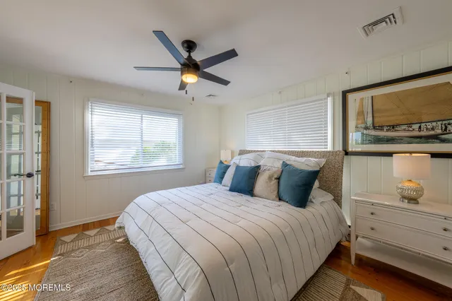 a bedroom with a large bed and a window