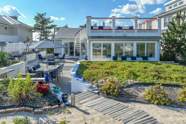 a view of a house with swimming pool and sitting area