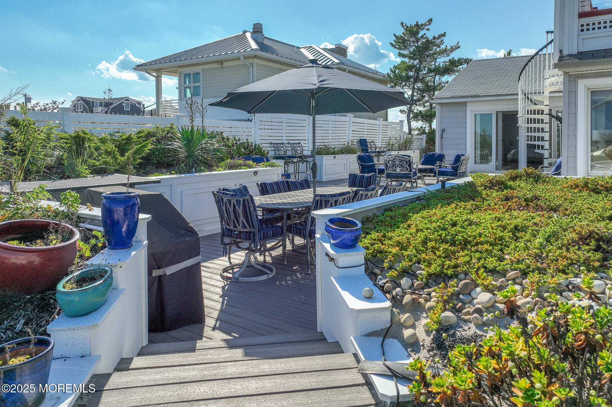 14 Falls Road Mantoloking, NJ 08738 - Photo 33 of 40 a view of a patio with couches table and chairs under an umbrella