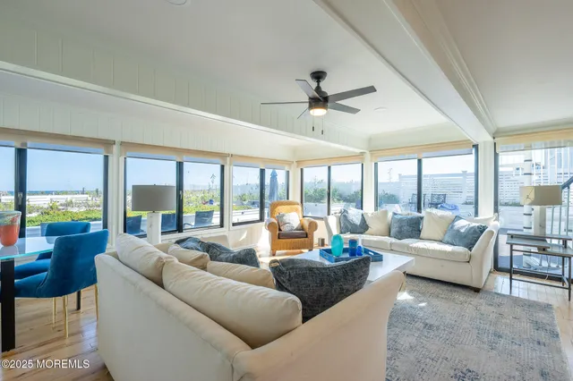 a living room with furniture and large windows
