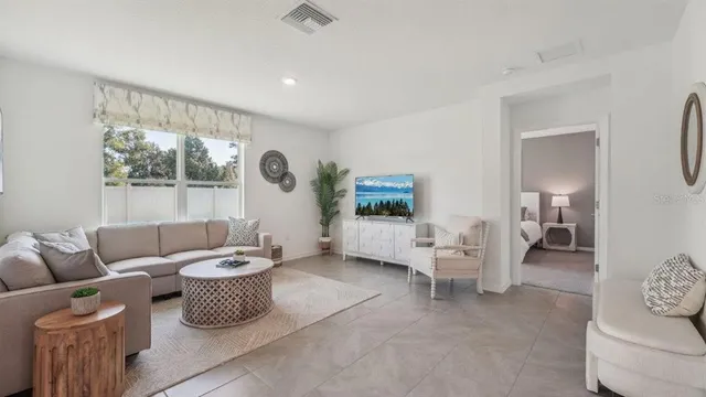 a living room with furniture and a large window