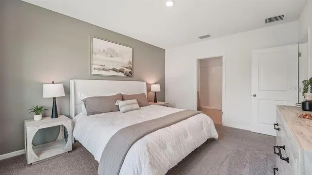 a bedroom with a bed and a desk