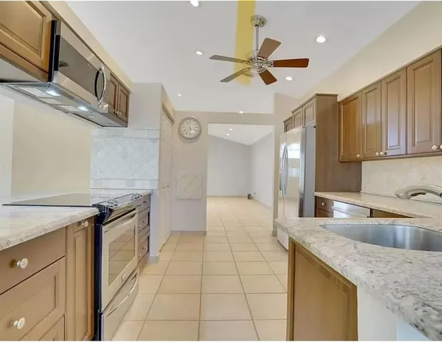 a kitchen with stainless steel appliances granite countertop a sink and cabinets