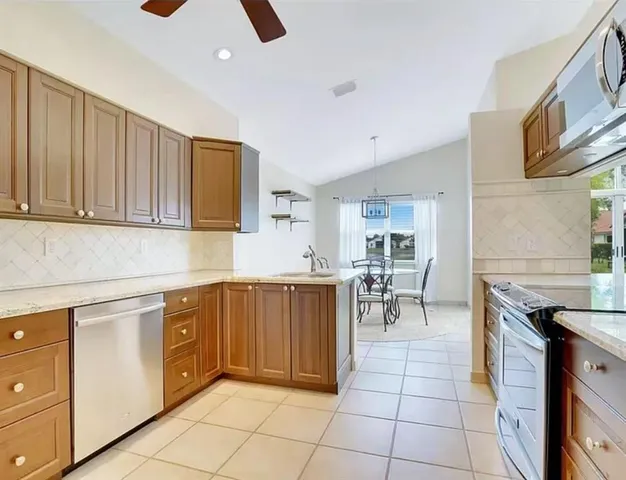 a kitchen with stainless steel appliances granite countertop a stove and a sink