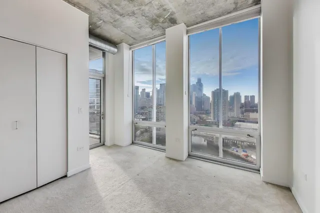 a view of empty room with floor to ceiling window