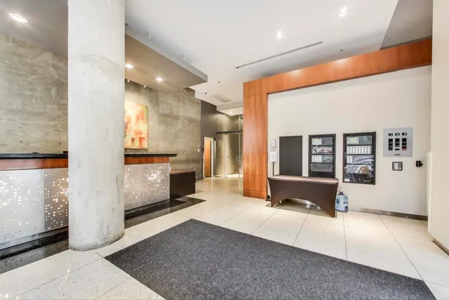 a living room with stainless steel appliances kitchen island granite countertop furniture and a fireplace