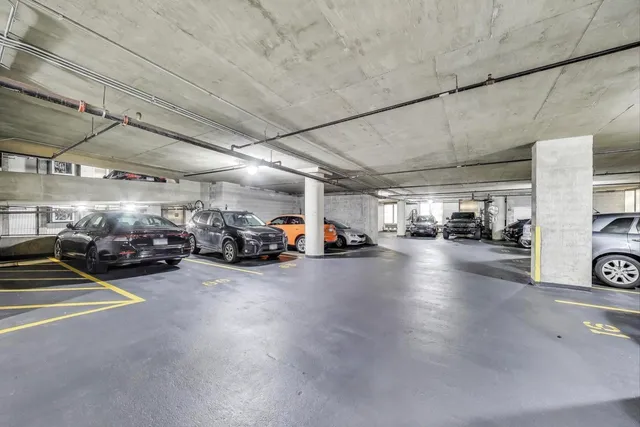 a view of parking area with parked cars