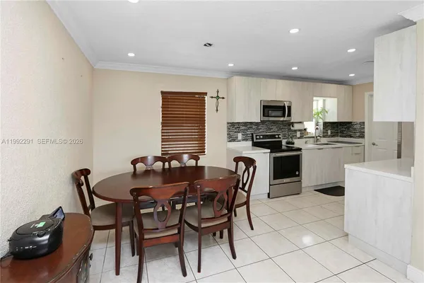 a dining room with furniture a window and kitchen view