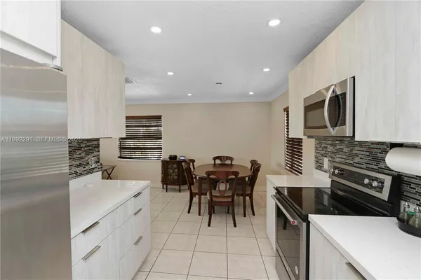 a kitchen with a cabinets and chairs