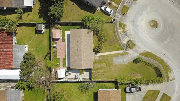 an aerial view of a house with a swimming pool