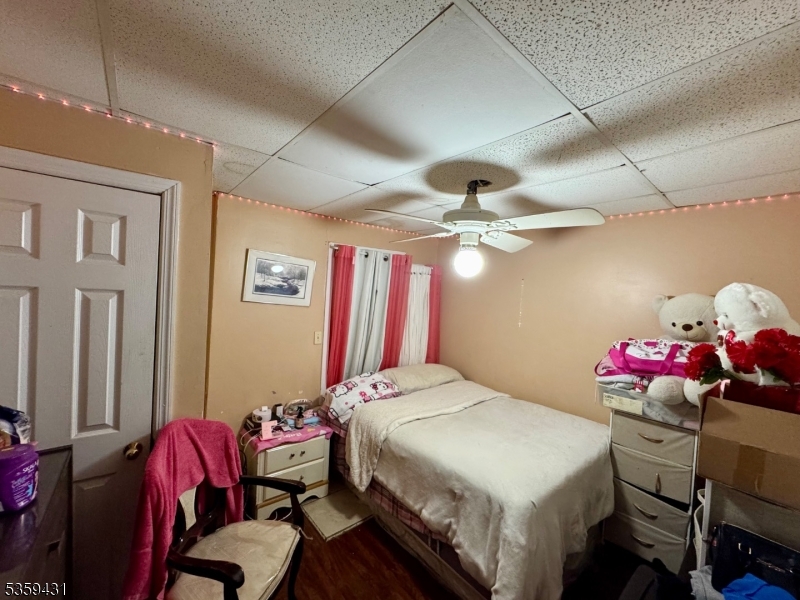 57 East Main Street Paterson, NJ 07522 - Photo 12 of 20 a bedroom with a bed and a chandelier
